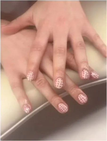 A pink and white polka-dot nail set