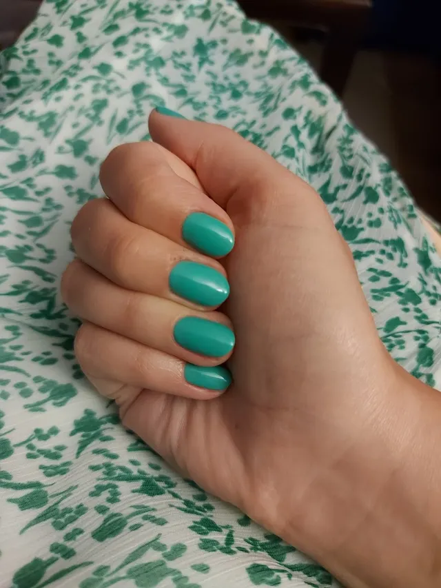A vivid teal gel manicure